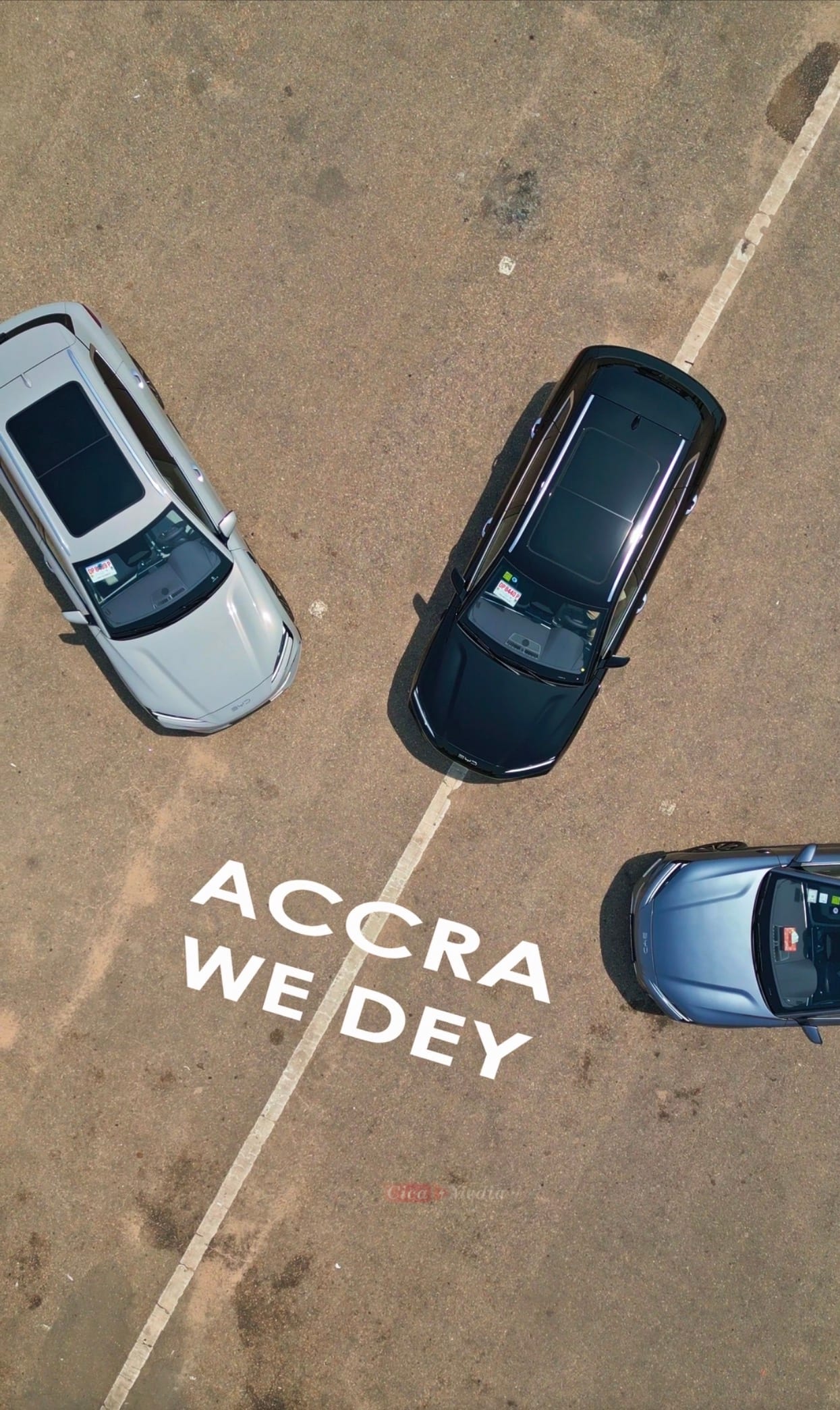 Aerial view of Transparent Rentals BYD Song Plus fleet with 'Accra We Dey' graphic overlay — three SUVs photographed from above at a parking location in Accra, Ghana
